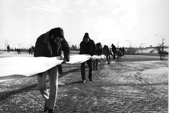 Glenn Lewis performing 400 Yards of Burned Paper in a Square with studetns in Calgary in 1969