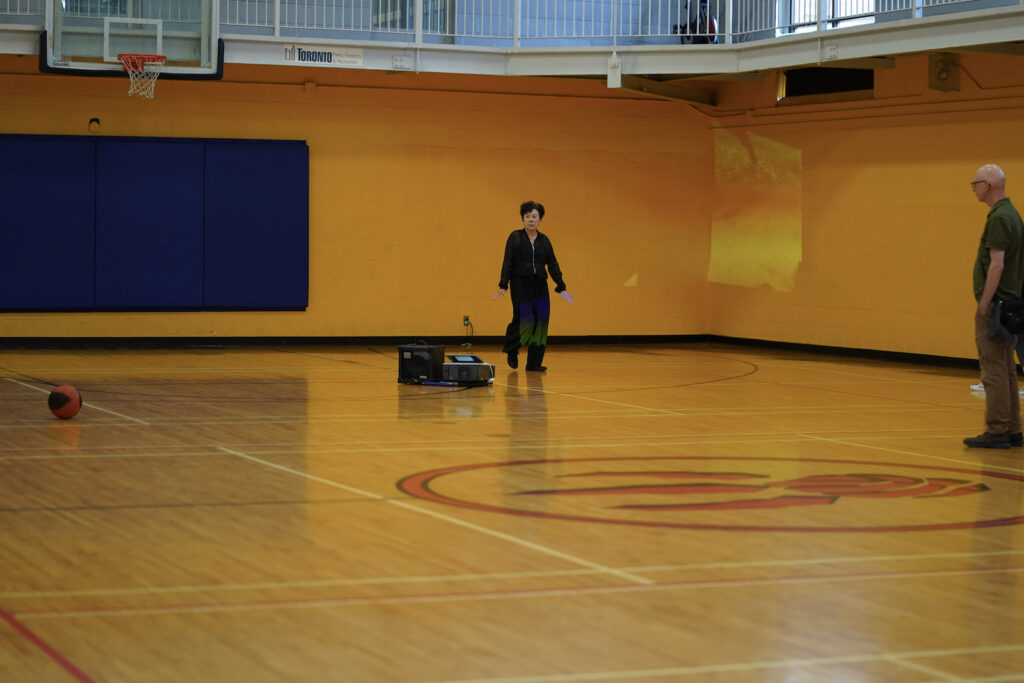 Sakiko Yamaoka and audience participant perform Body Maintenance as part of KinesTHESES, 2019