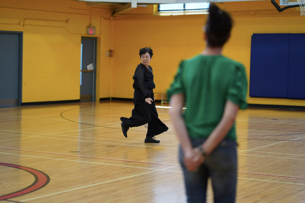 Sakiko Yamaoka and audience participant perform Body Maintenance as part of KinesTHESES, 2019