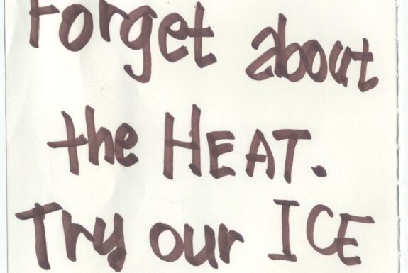 Notebook page from Step 2 with the words 'Enjoy and forget about the Heat, Try our Ice Latte' in thick black marker
