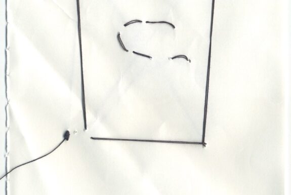 Notebook page from Step 2 with the outline of a rectangle with a curved line in the middle sewn in black thread
