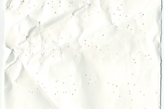 Notebook page from Step 2 with patterns of small holes made by a sewing needle