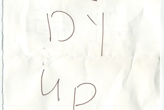 Notebook page from Step 2 with the words 'Tidy up' in fine black ink. The 'i' in Tidy is written over the letter 'u'.