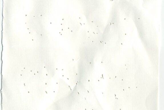 Notebook page from Step 2 with patterns of small holes made by a sewing needle