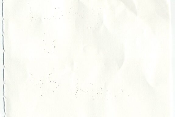 Notebook page from Step 2 with patterns of small holes made by a sewing needle