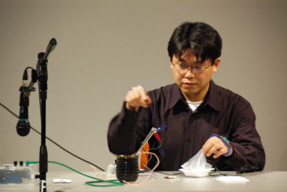 Adachi Tomomi performing Japanese Sound Poetry Improvisation Electric Chopsticks & Cup at XPACE Cultural Centre