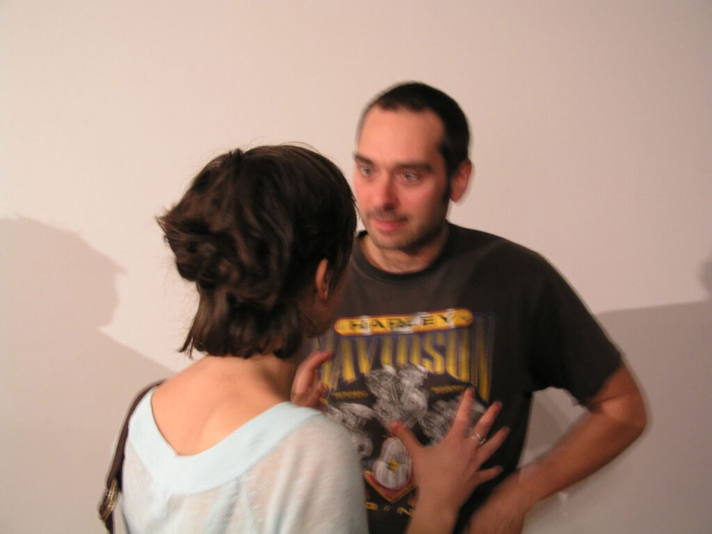 Éric Létourneau speaking with an audience member 7a*11d 2004